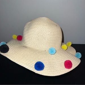 Woven wide brim hat with polka dot rainbow Pom poms